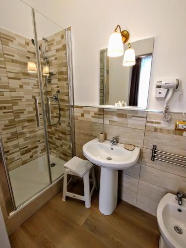 a bathroom with a sink and a shower at Le Camere di Suleima in Messina