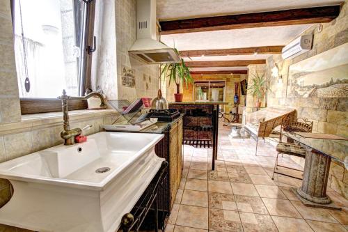 a kitchen with a white sink in a room at Villa da Winci in Odesa