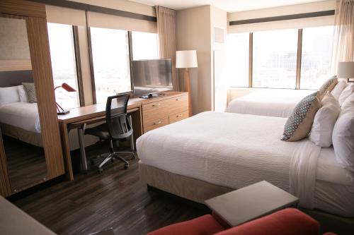 a hotel room with two beds and a desk with a computer at TownePlace Suites by Marriott New Orleans Downtown/Canal Street in New Orleans