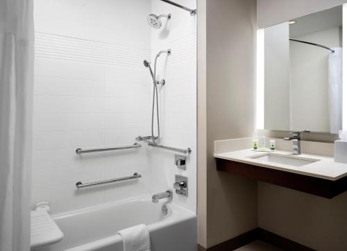 a bathroom with a bath tub and a sink at TownePlace Suites by Marriott New Orleans Downtown/Canal Street in New Orleans