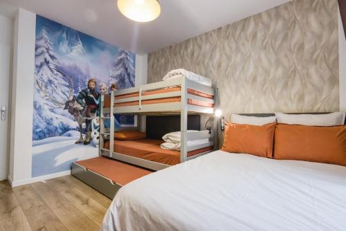 a bedroom with a bunk bed and a mural at Aurelia - Cosy & Chic - 10min Disney - by Cosynousvoici in Chessy