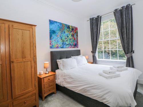 a bedroom with a bed and a window at Gulliver's in Matlock