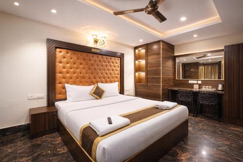 a bedroom with a large bed and a bar at Hotel Well Suites Koramangala in Bangalore