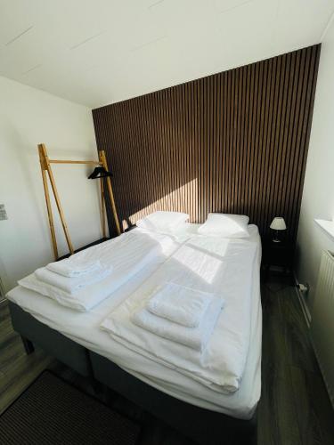 a bed with white sheets and towels on it at Entire Home in Billund Center in Billund