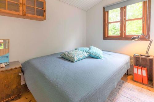 a bedroom with a bed with two pillows on it at 16664-Farevejle-Klinteborgvej-7 in Fårevejle