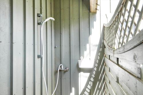 a hose hooked up to a wall with a sink at 12228-Sjaellands-Odde-Strandvaenget-23 in Yderby