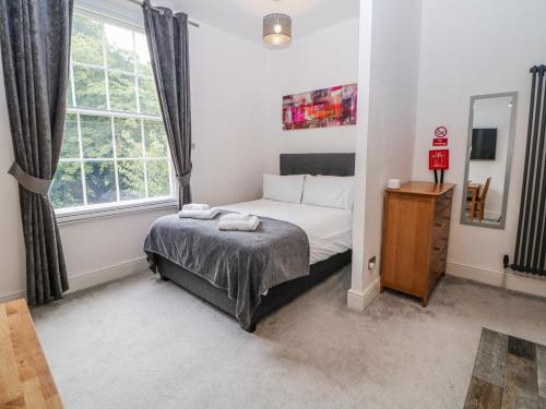 a bedroom with a bed and a window at Masson in Matlock