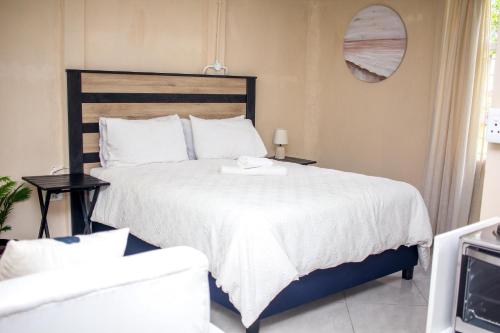 a bedroom with a large bed with a white comforter at Revitalize in Springs
