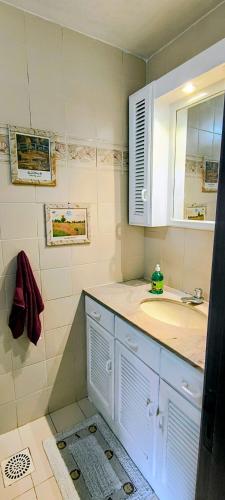 a bathroom with a sink and a mirror at 203 Barra Refúgio in Tramandaí