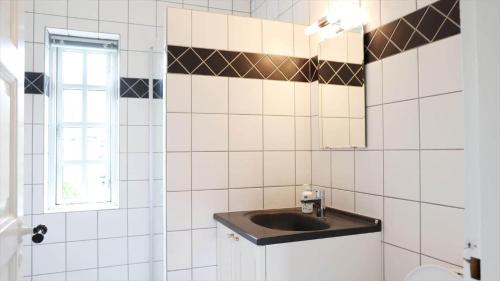 a bathroom with a sink and a mirror at 10098-Rorvig-Fjordvaenget-17 in Rørvig