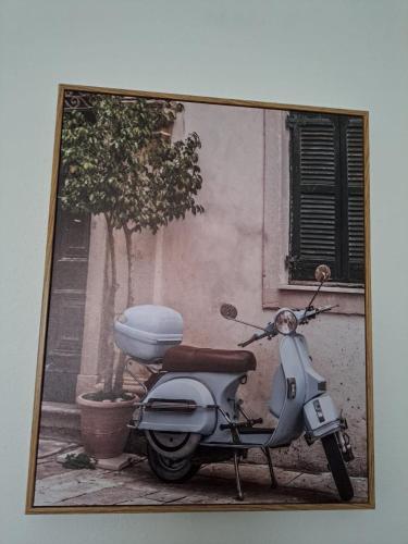 a picture of a scooter parked in front of a building at Alojamento Local Santo António in Montemor-o-Velho