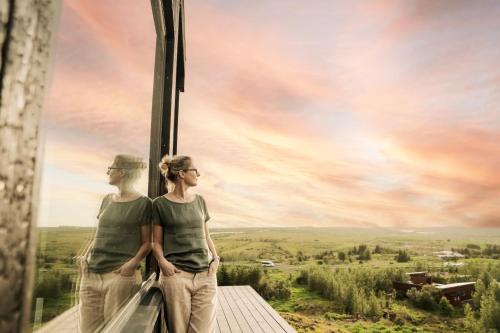 two women standing on a balcony looking out at the sky at Black Diamond Villa in Mosfellsbær