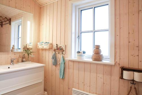 a bathroom with a sink and a mirror at 17716-Horve-Strandlunden-60 in Hørve