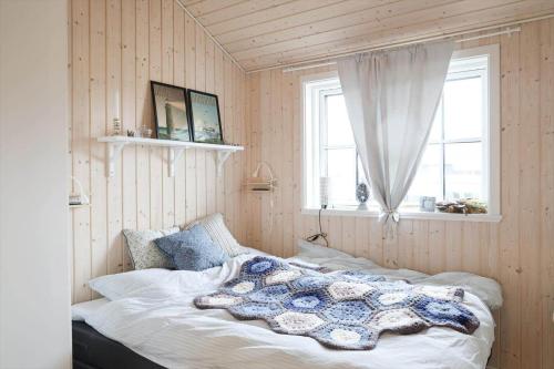 a bedroom with a bed in a room with a window at 17716-Horve-Strandlunden-60 in Hørve