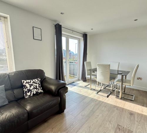 a living room with a couch and a table at Modern 2 Bedroom 2 Bathroom City Apartment Free Parking in Newcastle upon Tyne