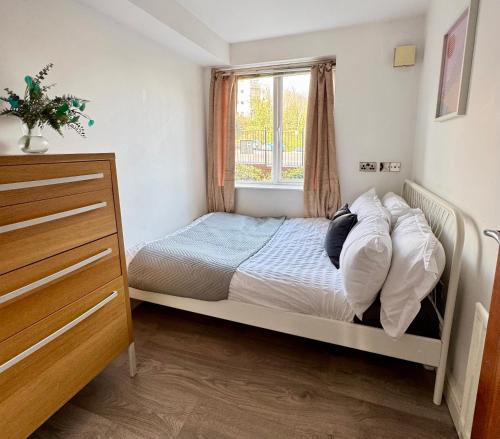 a small bedroom with a bed and a window at Modern 2 Bedroom 2 Bathroom City Apartment Free Parking in Newcastle upon Tyne