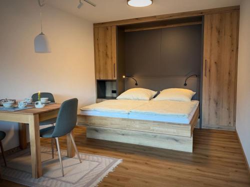 a bedroom with a large bed and a desk at Ferienwohnung Gipfeltraum in Berchtesgaden