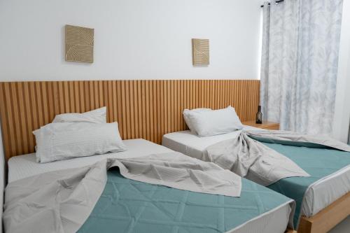 two beds sitting next to each other in a room at Salt & Sand T3 in Praia