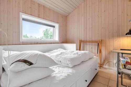 a white bed in a room with a window at 14233-Grevinge-Grevinge-Kanalvej-95 in Grevinge