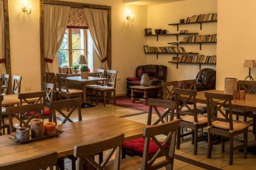 a dining room with tables and chairs and a window at Dworek Szwajcaria in Zwardoń