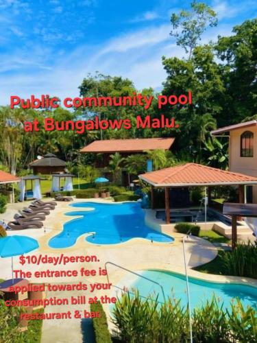 a pool at a resort with the words public community pool at showers mall at Apartment by the Caribbean sea in Cahuita