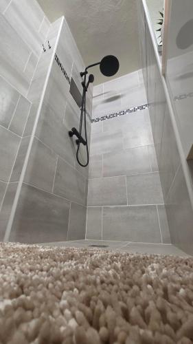 a shower in a bathroom with a floor at Villa Maxime in Sainte-Marie