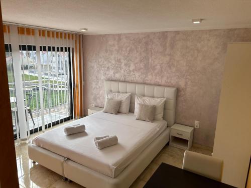 a bedroom with a large bed and a large window at Bonavita Zaton in Zaton