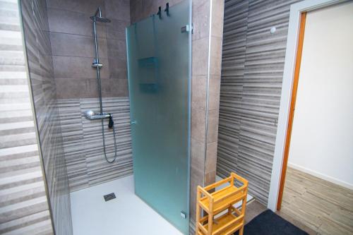 a shower with a glass door in a bathroom at Hostel D'Avenida in Vila Praia de Âncora