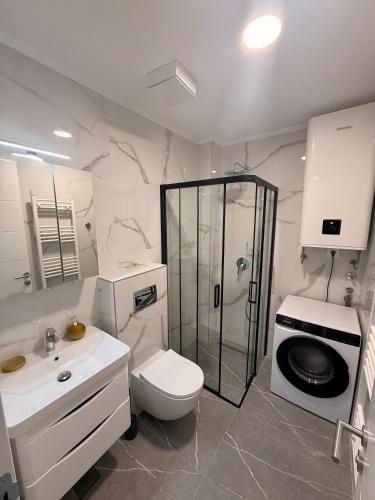 a bathroom with a shower and a toilet and a sink at NOIR Luxury in Trebinje