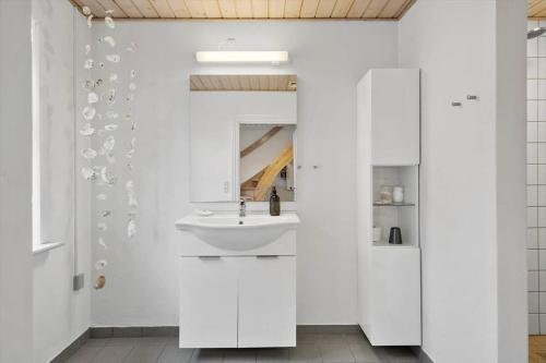 a white bathroom with a sink and a mirror at LF11975-Struer-Havstokken-12 in Vemb
