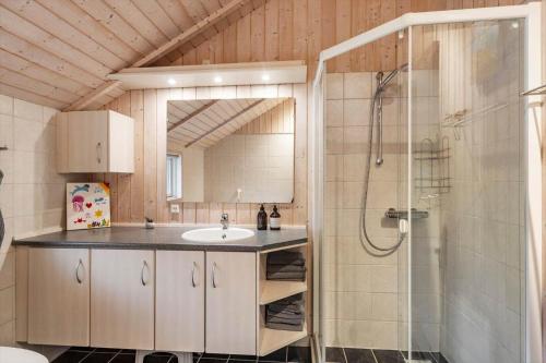 a bathroom with a sink and a shower at LF10208-Struer-Skovstien-8 in Jegind