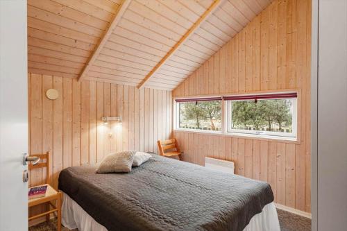 a bedroom with a bed in a room with a window at LF10208-Struer-Skovstien-8 in Jegind