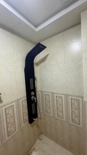 a bathroom with a shower with a phone on the wall at apartment for rent in Islamabad