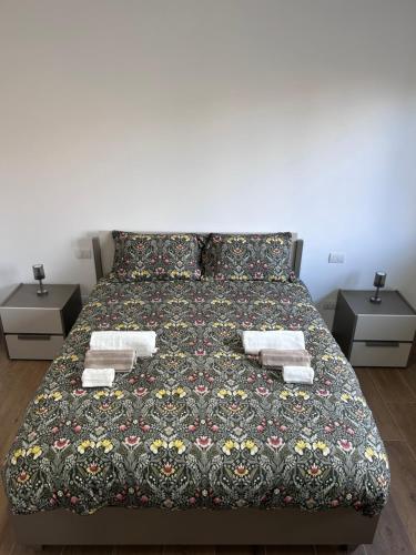 a bedroom with a bed with two night stands at NUVOLA Hosting in Segrate