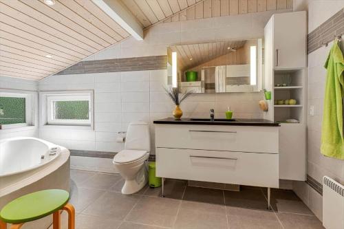 a white bathroom with a sink and a toilet at BV406-Blavand-Tvaervaenget-2 in Blåvand
