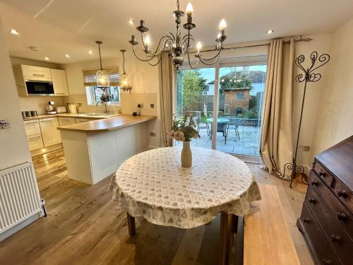 a kitchen with a table with a vase on it at Bright 3 bed House,FREE parking,Garden,nr seafront in Brighton & Hove