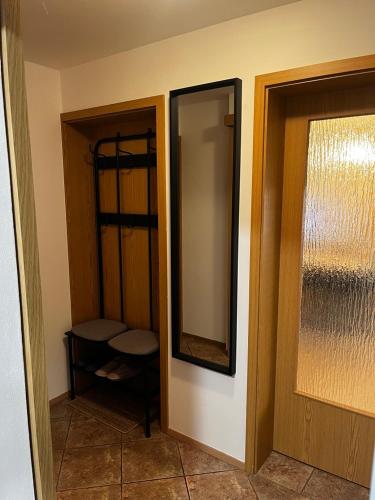 a bathroom with a mirror on the wall at Rumena hiša in Trnovo