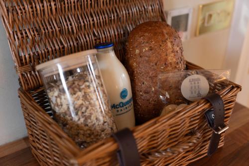 a basket with bread and milk and some food at The Townhouse, Leith in Edinburgh