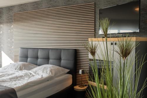 a bedroom with a large bed with a large television at Studio Relax in Büsum