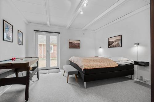 a bedroom with a bed and a ping pong table at BV230-Blavand-Vesterhavsparken-35 in Blåvand