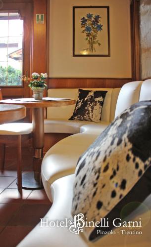 a living room with couches and a table at Hotel Binelli in Pinzolo