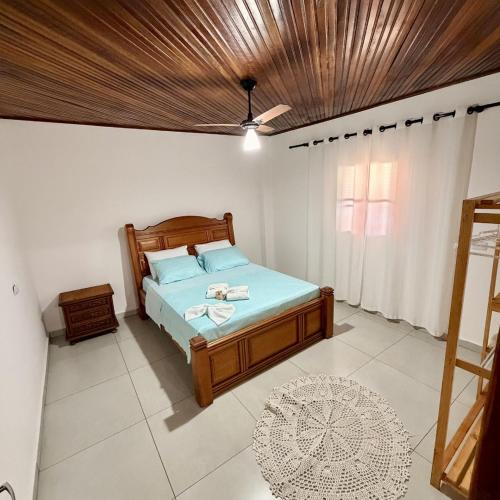a bedroom with a bed with a wooden ceiling at Casa 2 - Top Country Ranch in Boituva