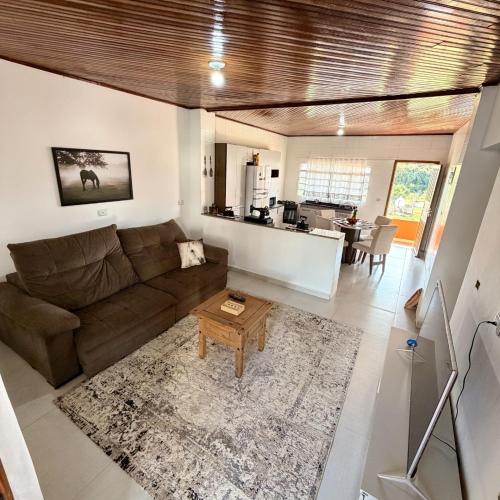 a living room with a couch and a table at Casa 2 - Top Country Ranch in Boituva