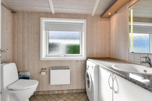 a bathroom with a toilet sink and a washing machine at BV347-Esbjerg-V-Sjelborgdalen-22 in Esbjerg