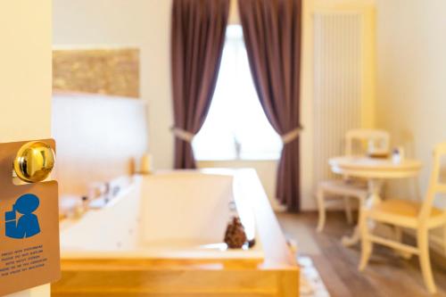 a bedroom with a bed and a table in a room at Casa Leon d'Oro in Bosco Chiesanuova