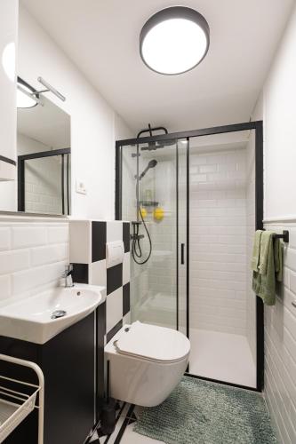 a bathroom with a shower and a toilet and a sink at Lemon apartment Piran in Piran