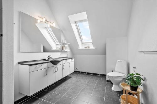 a white bathroom with a sink and a toilet at BV326-Blavand-Blavandvej-4-2 in Blåvand