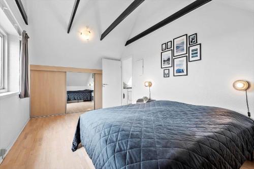 a bedroom with a large bed and a fireplace at BV326-Blavand-Blavandvej-4-2 in Blåvand