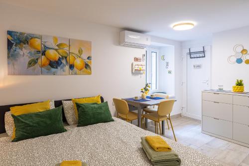 a living room with a bed and a dining room table at Lemon apartment Piran in Piran