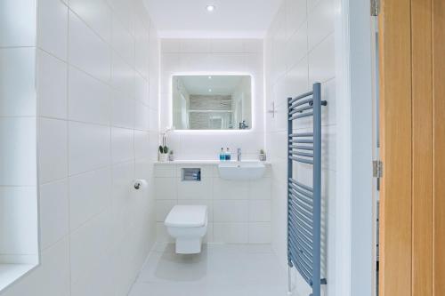 a white bathroom with a toilet and a sink at Connel House - Luxury self-catering 4-bedroom home in Connel